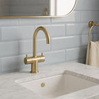 Brushed brass deck mounted basin tap with swivel spout