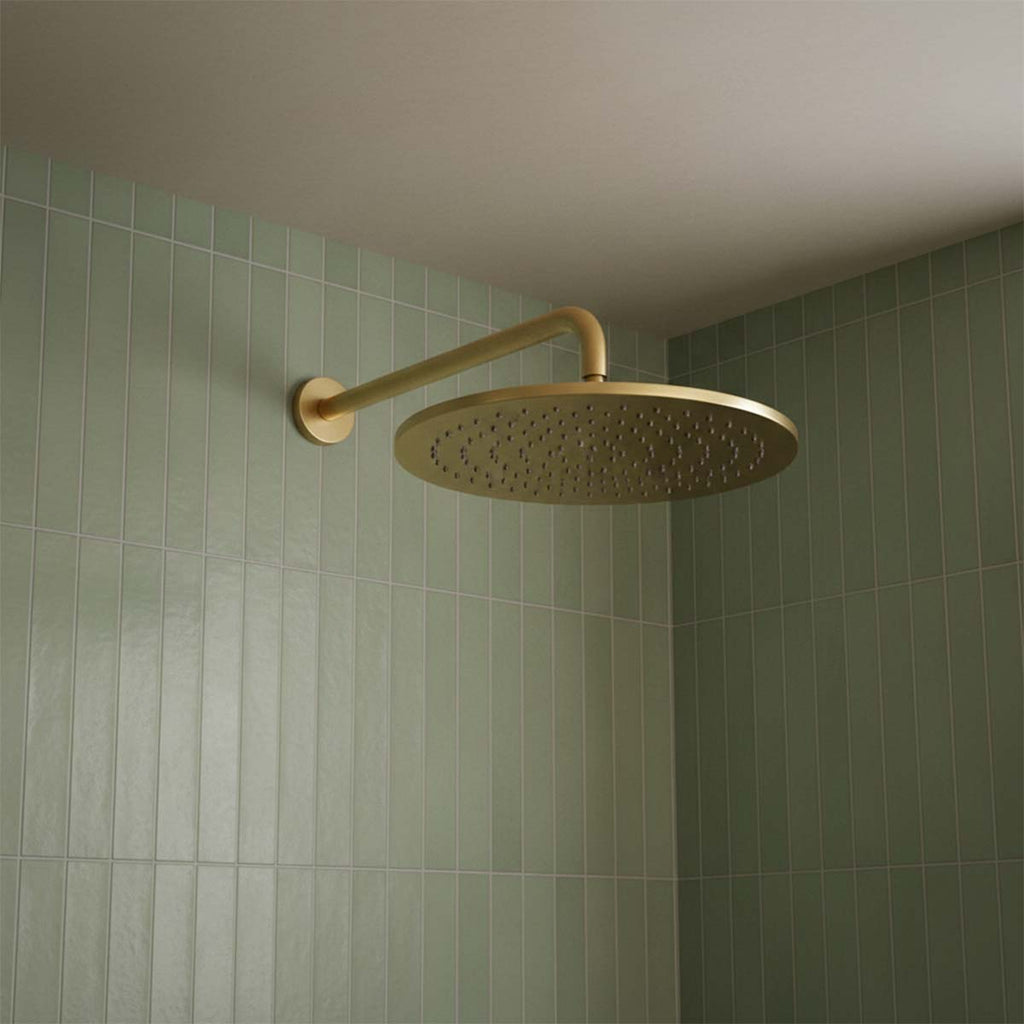 brushed brass shower head and arm wall mounted