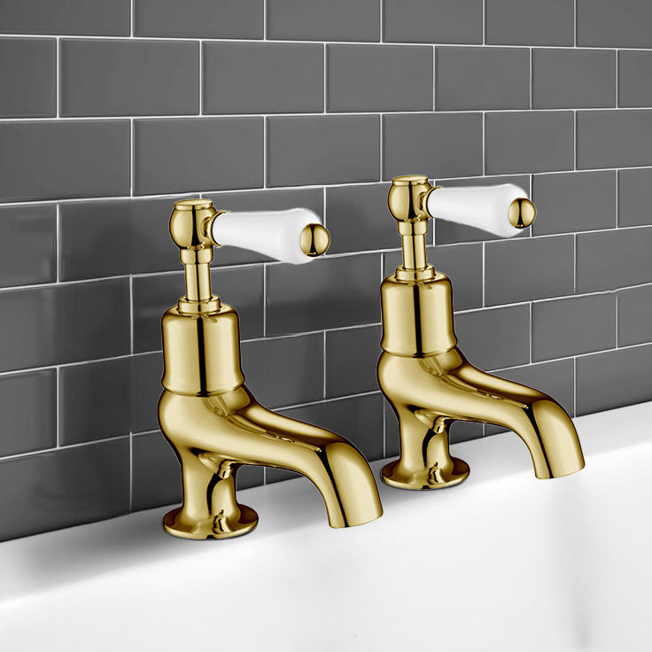 gold bath pillar taps with lever handles