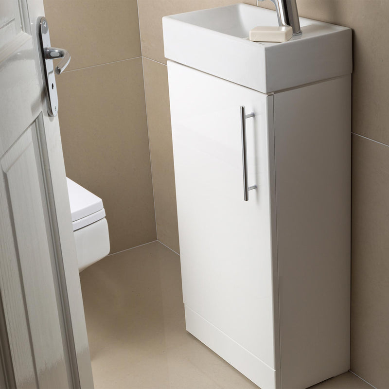 White Floor Mounted Vanity Unit with Single Door and Basin in a small bathroom with brown tiles