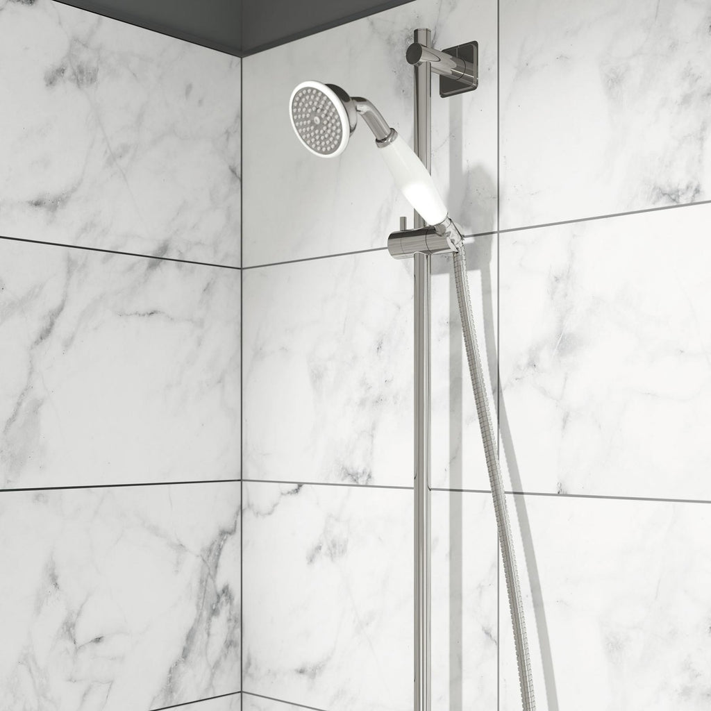 Shower rail kit with traditional handset fixed in a shower bracket installed on a white tilled bathroom wall 