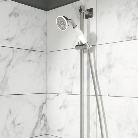 Shower rail kit with traditional handset fixed in a shower bracket installed on a white tilled bathroom wall 